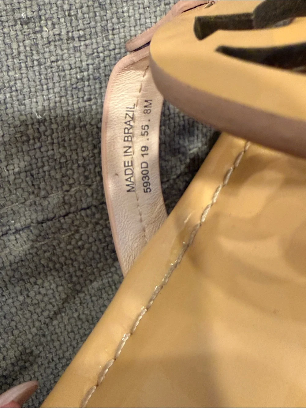 Tory Burch Patent Leather Thong Sandals  color is a pinky peach nude color.